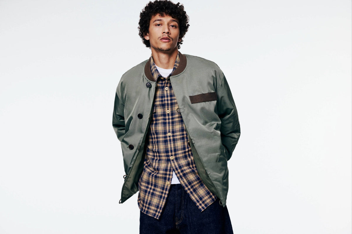 A model wears the Visvim Corps Bomber Jacket