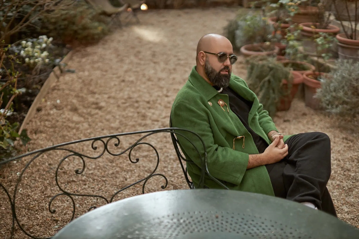 Charaf Tajer sat in a garden.