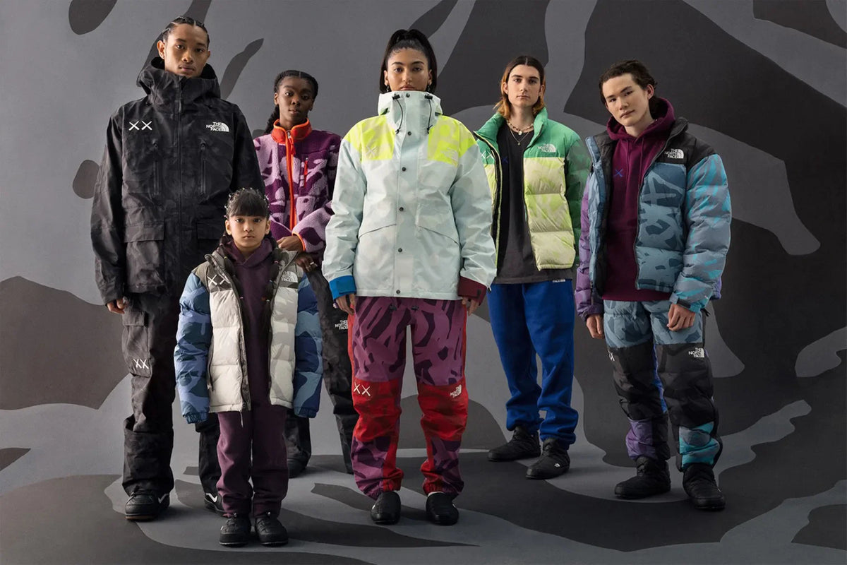 Group wearing vibrant clothing from The North Face x KAWS "XX KAWS" collection
