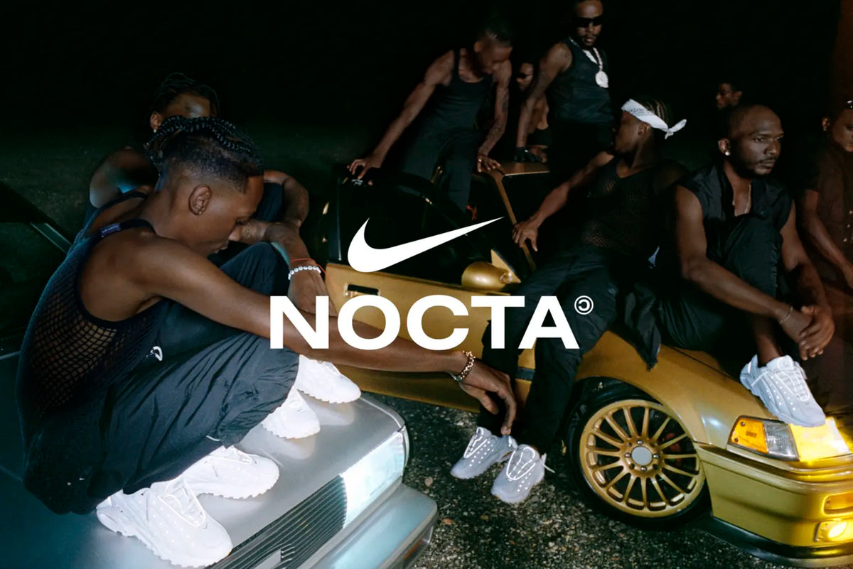 Men sitting on a car wearing the NIKE NOCTA HOT STEP AIR TERRA sneakers.