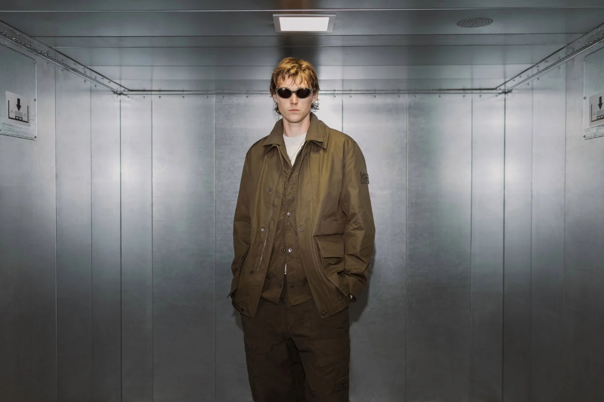 A model wears a Stone Island Ghost Overshirt in brown