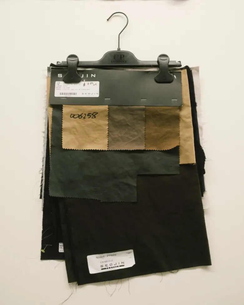 swatches of fabric on a hanger in a workshop