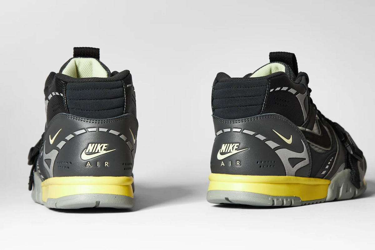 Back view of Nike Air Trainer 1 SP sneakers, highlighting the yellow midsole accent and padded ankle collar.