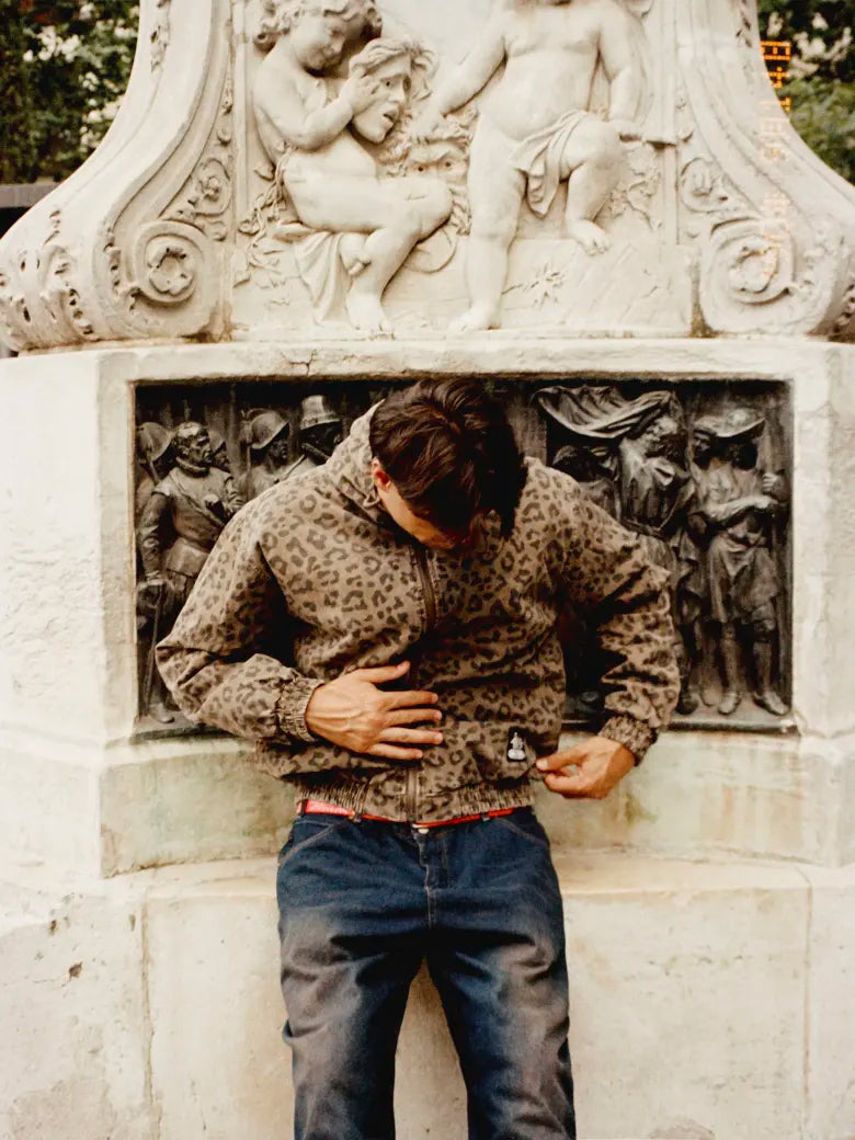 A model wears a Butter Goods zipped work jacket in leopard print