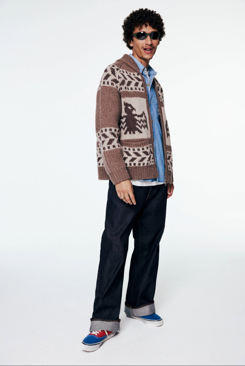 A model wears FrizmWORKS knitwear