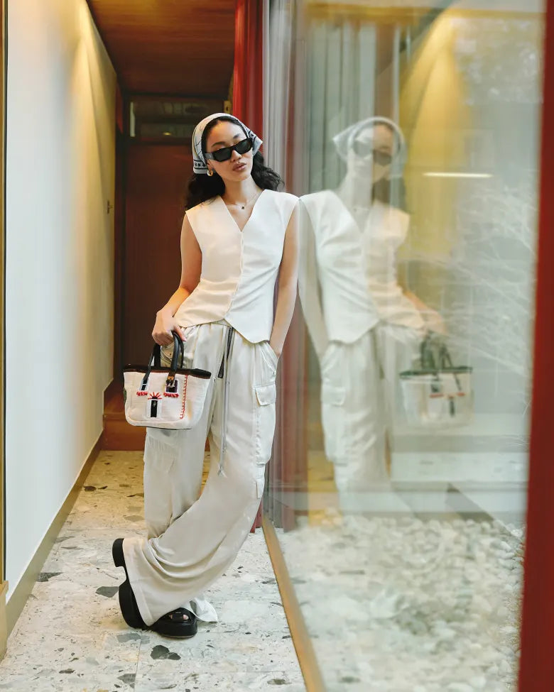 END. Spring 25 Editorial model wearing a St Agni waistcoat, Rick Owens trousers, platform sandals, and a headscarf with sunglasses.