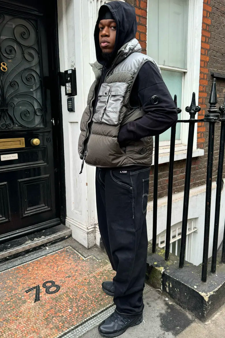 A man wearing a streetwear look from an END. editorial on styling the New Balance M1906R sneaker.