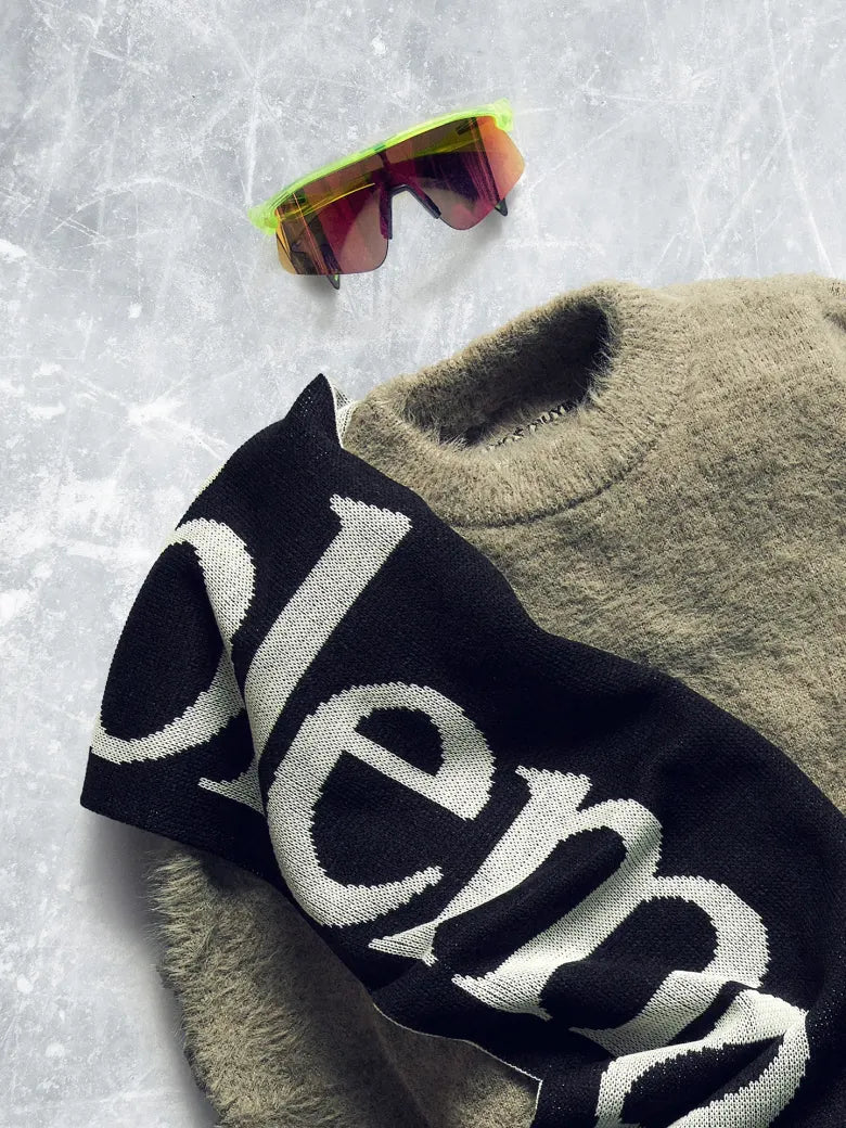Scarf, knitted jumper and ski sunglasses