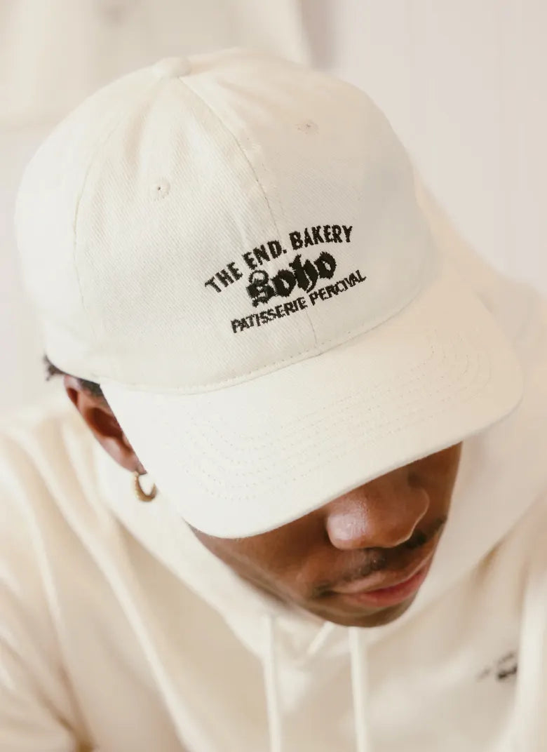 Man in bakery wearing a Percival cap