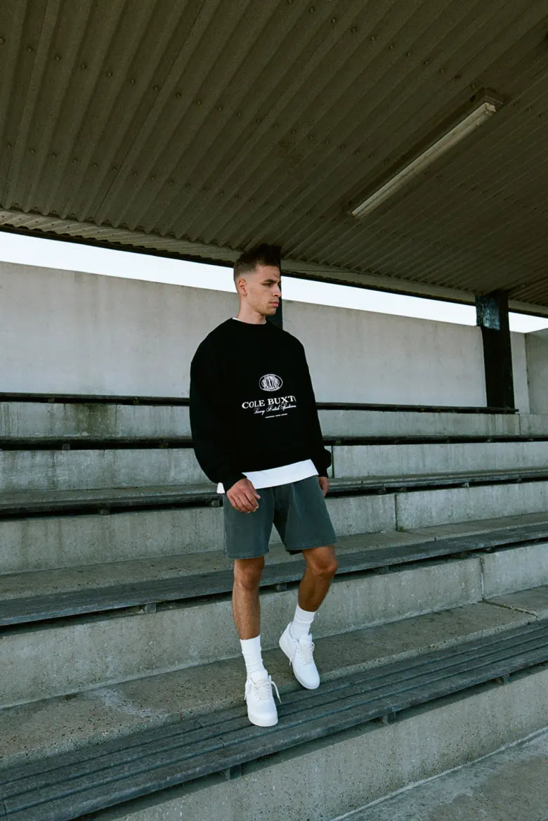 Man wearing Cole Buxton half zip sweatshirt
