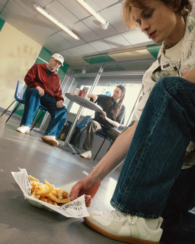 Adidas Army BW sneakers next to a portion of chips