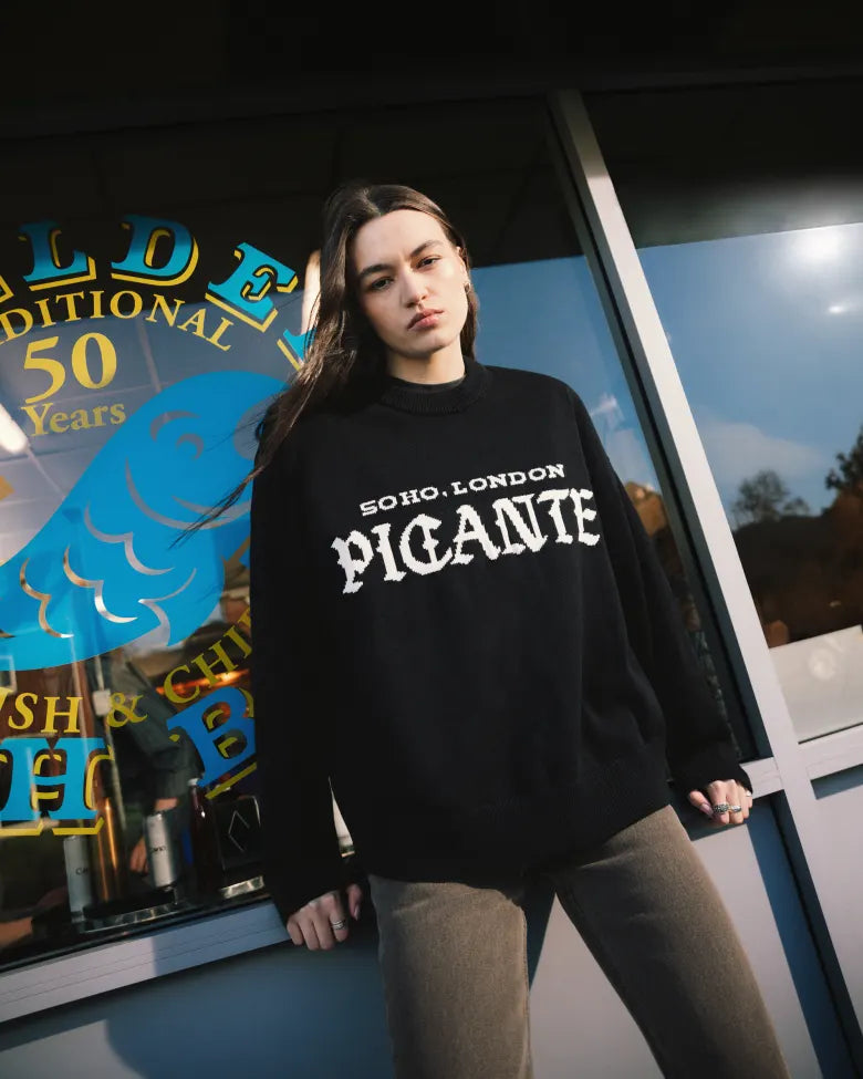 Woman wearing a Picante jumper outside a chip shop