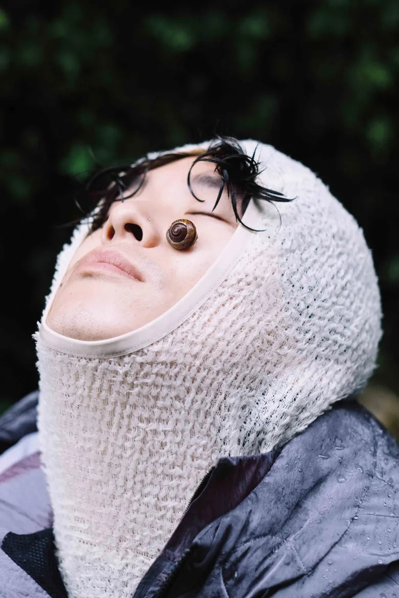 A man with a snail on his face.