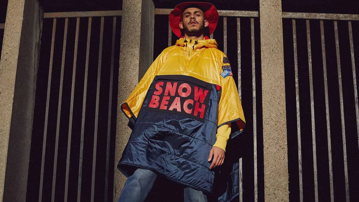 Editorial image of a man wearing a Polo Ralph Lauren Snow Beach poncho and bucket hat from the Polo Ralph Lauren commemorative capsule.