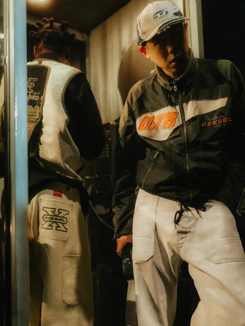 Photoshoot from END. X DIESEL collection featuring models in a phonebox