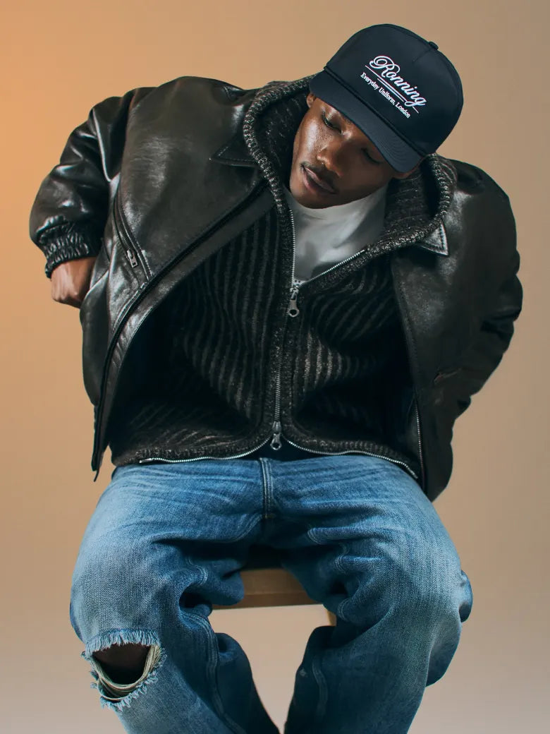 Man wearing leather jacket and cap