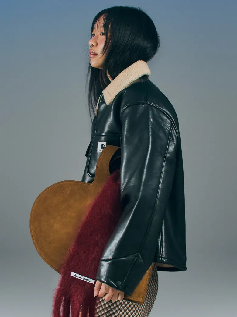 Woman wearing leather jacket with shearling collar