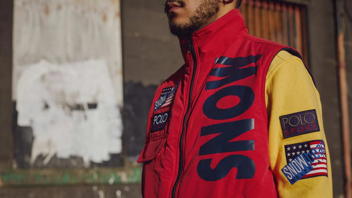 Editorial image of a man wearing a bold, colourful Polo Ralph Lauren Snow Beach gilet from the commemorative capsule.