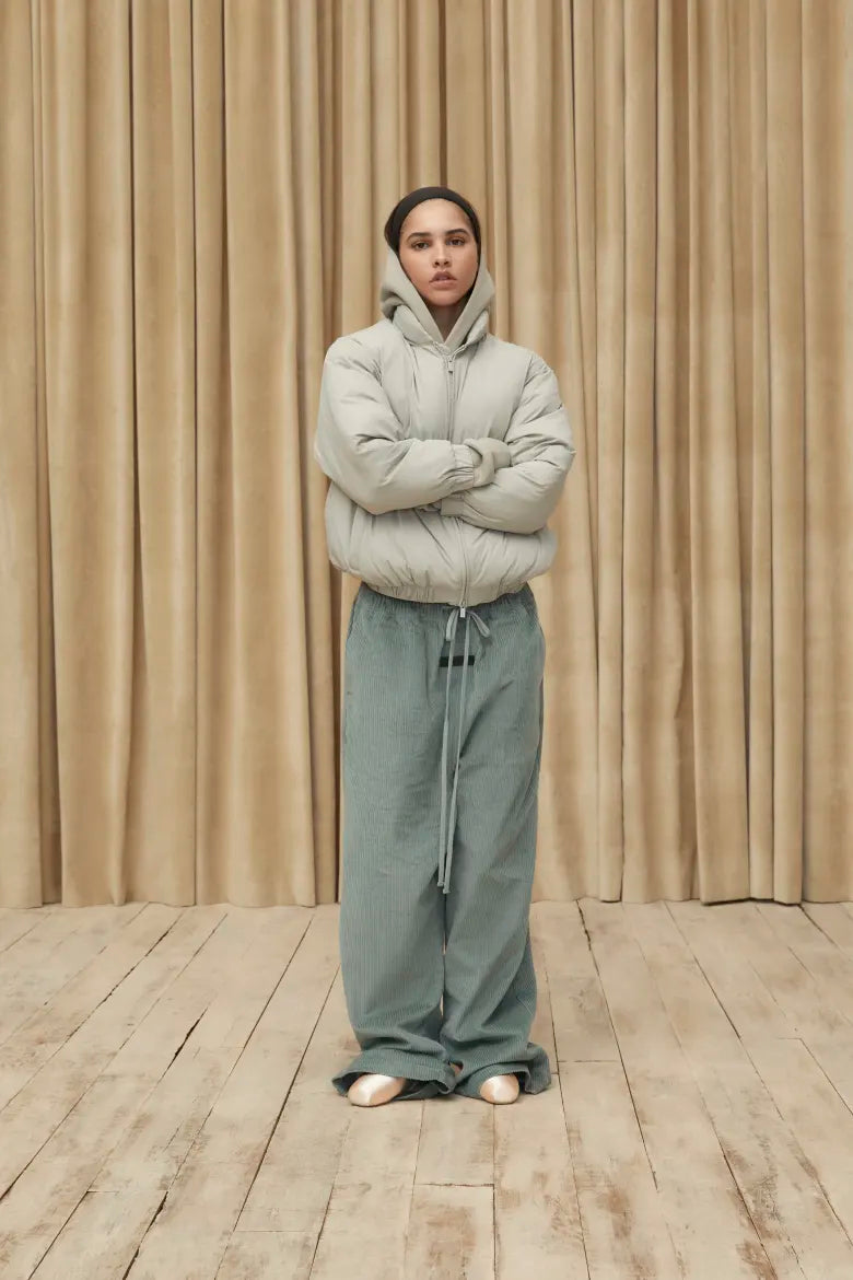 Woman wearing jacket and sweat pants from the Fear of God ESSENTIALS Spring 23 collection