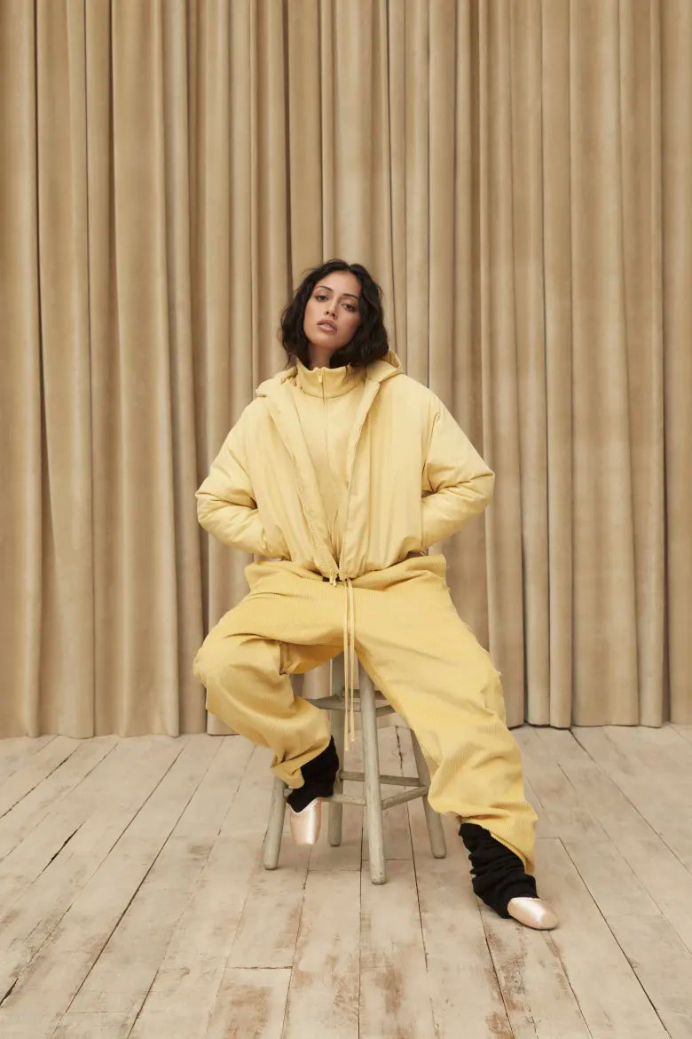 Woman wearing jacket and sweat pants from the Fear of God ESSENTIALS Spring 23 collection