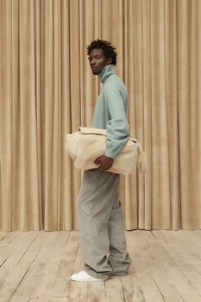 Man wearing sweatshirt and sweat pants from the Fear of God ESSENTIALS Spring 23 collection