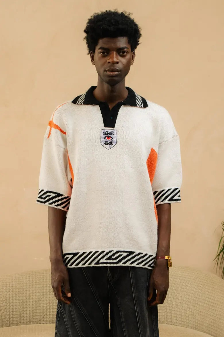 A person wearing the House of Errors knitted England football jersey.