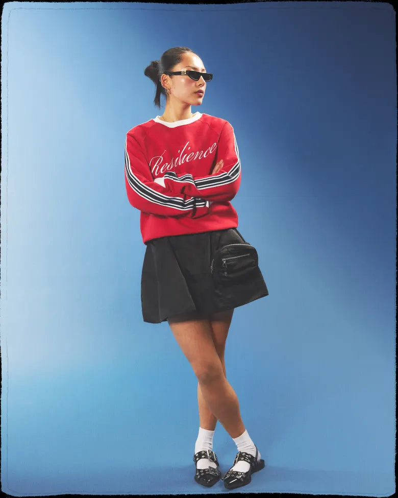 GANNI loafers with varsity style jumper and cargo shorts