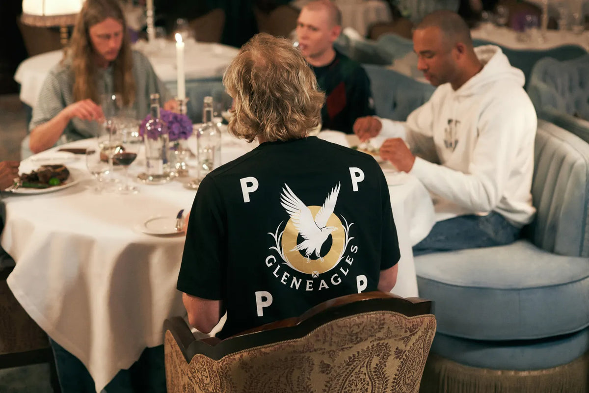 Man wearing a Pop Trading Company and Gleneagles collaboration t-shirt