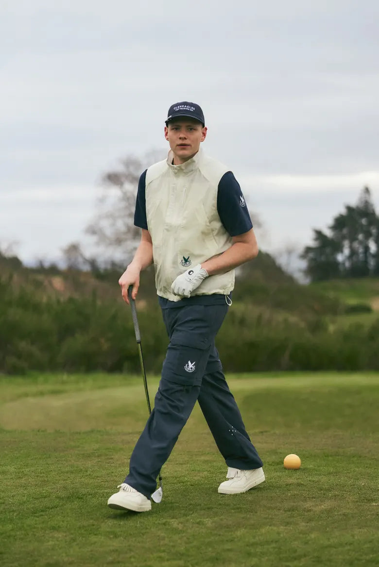 Man playing golf wearing Pop Trading Company and Gleneagles collaboration clothing