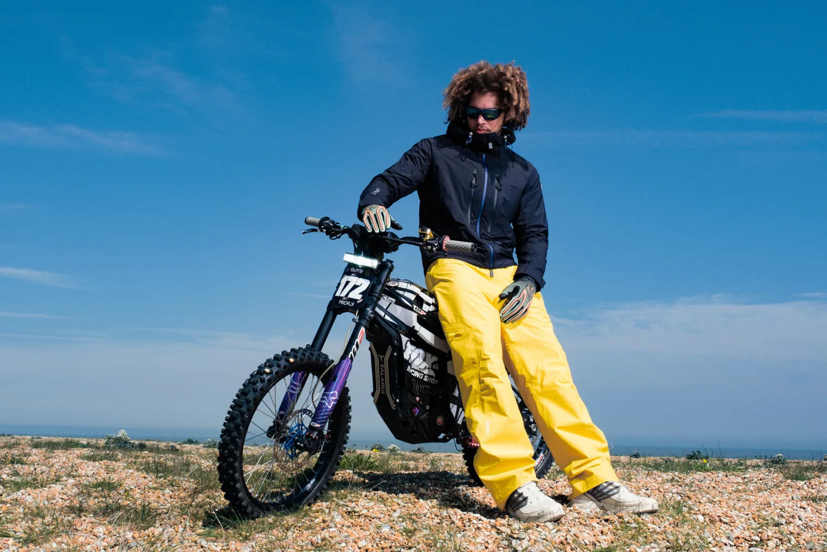 Rapper Joe James sitting on a Surron bike