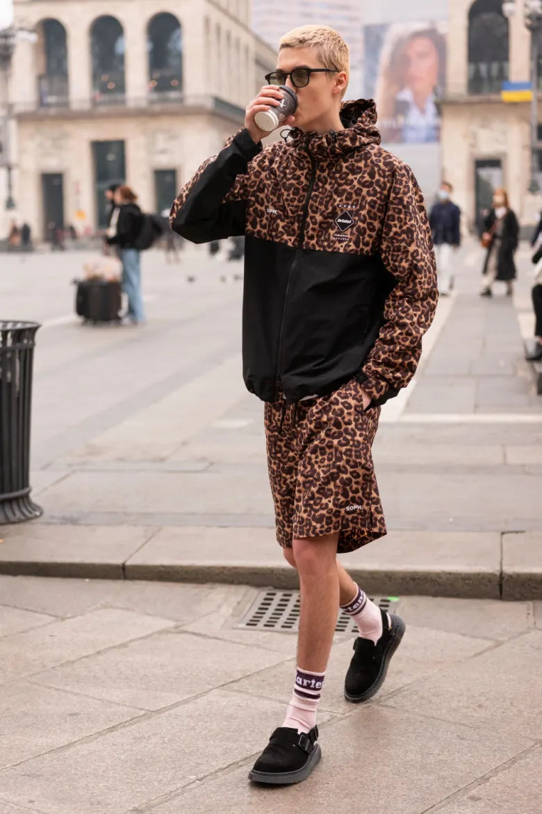 Man drinking coffee with Dr. Martens’ Jorge Mule on feet