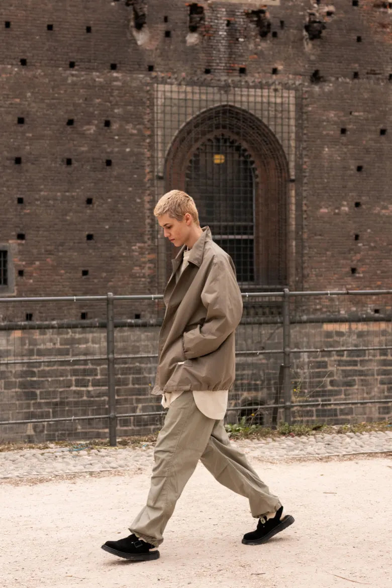 Man walking through city with Dr. Martens’ Jorge Mule on feet