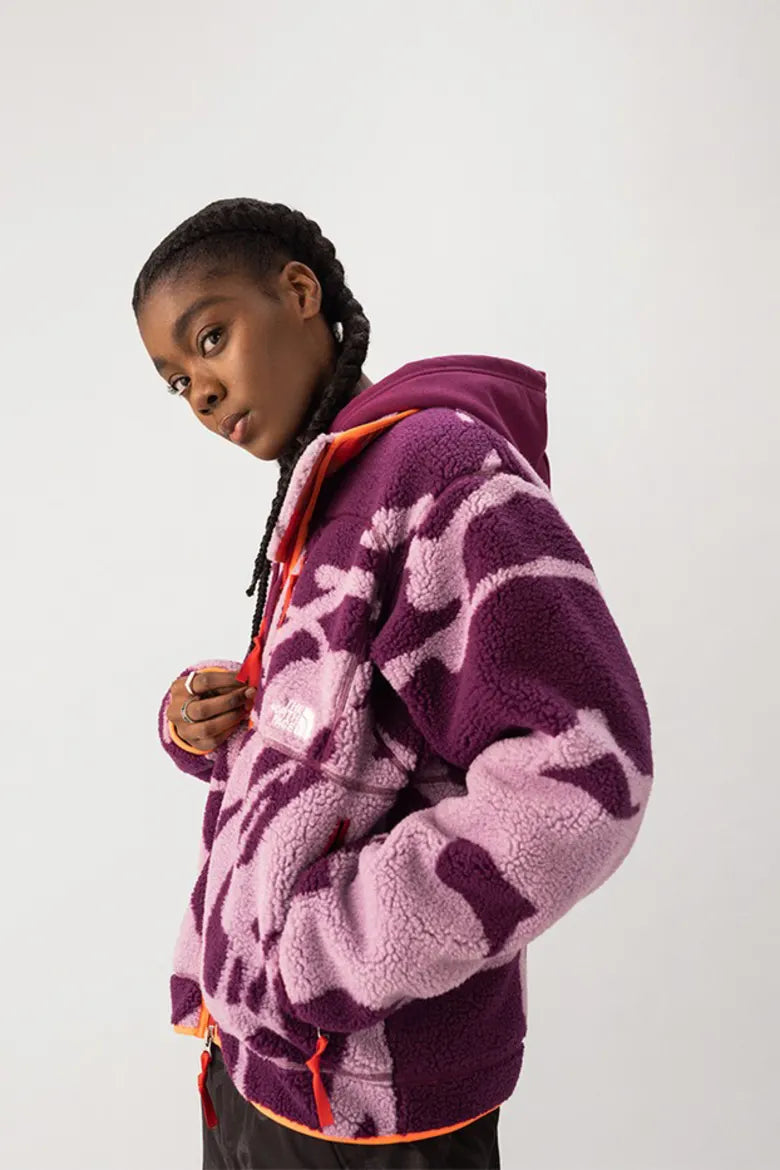 Model wearing vibrant fleece from The North Face x KAWS "XX KAWS" collection