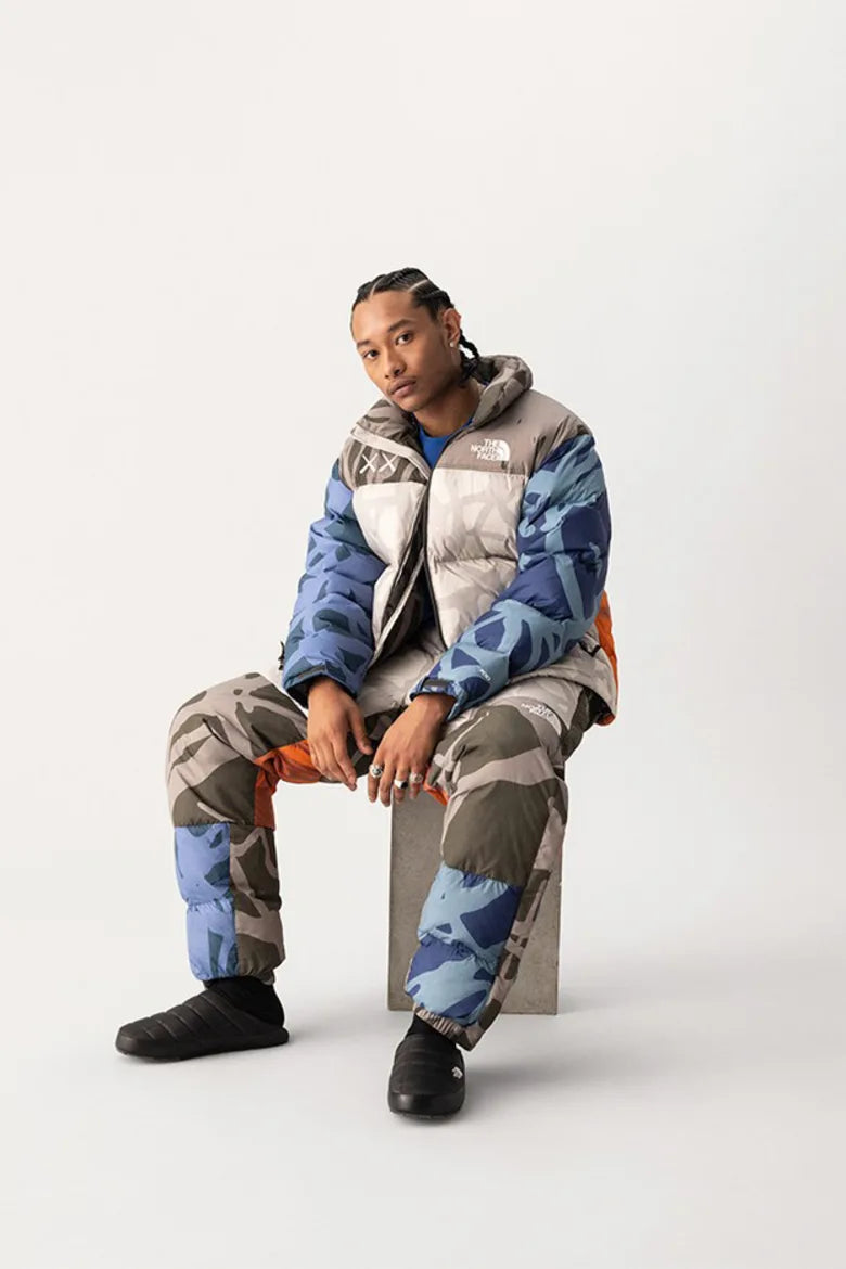 Model wearing vibrant jacket from The North Face x KAWS "XX KAWS" collection
