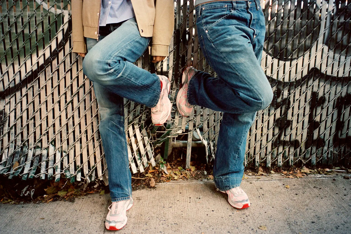 Two people wearing the Salomon x Sandy Liang XT-Whisper sneakers.