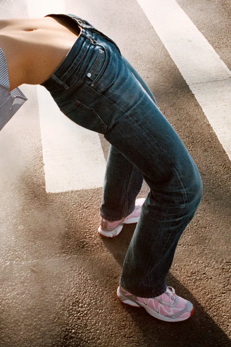 A lady bending backwards wearing the Salomon x Sandy Liang XT-Whisper sneakers.