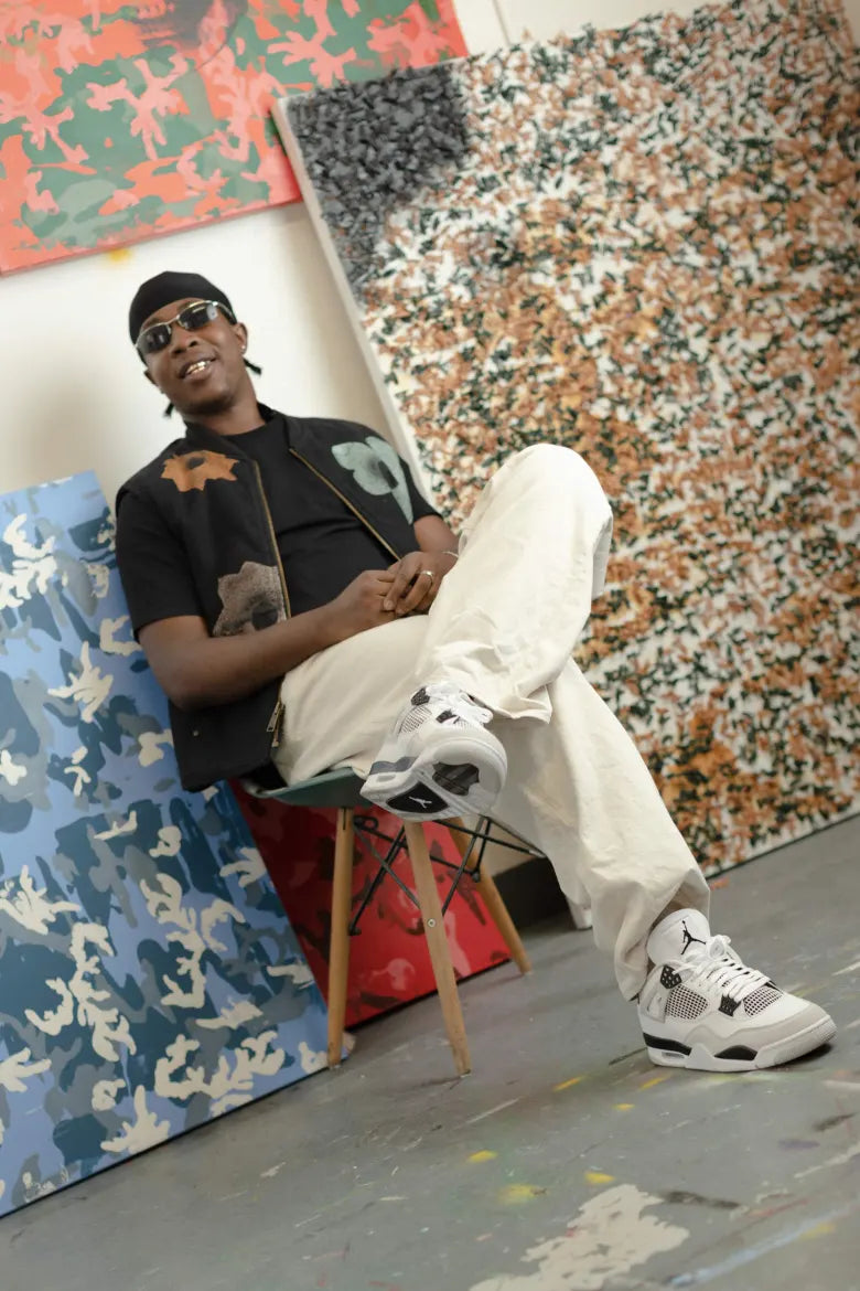Model wearing Air Jordan 4 "Military Black" sneaker