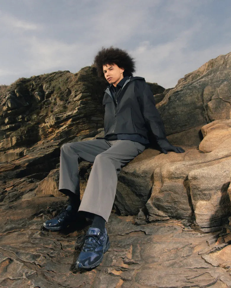 A man wearing the END. x Mizuno Wave Rider 10 sneakers.