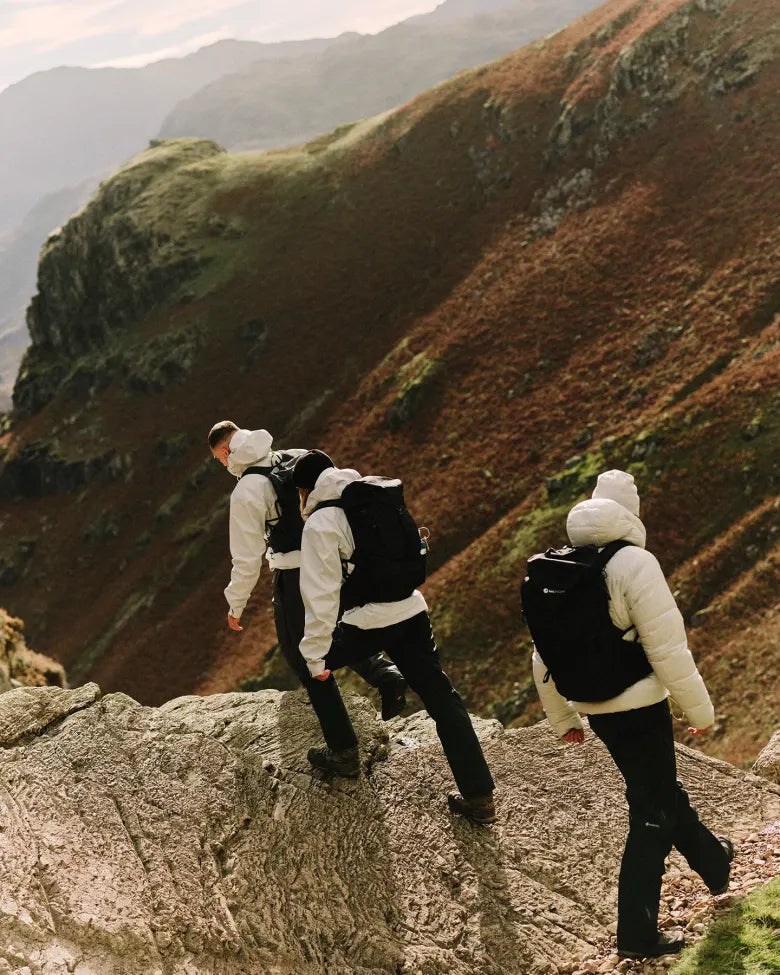 Three people wearing END. x Montane outerwear while hiking.