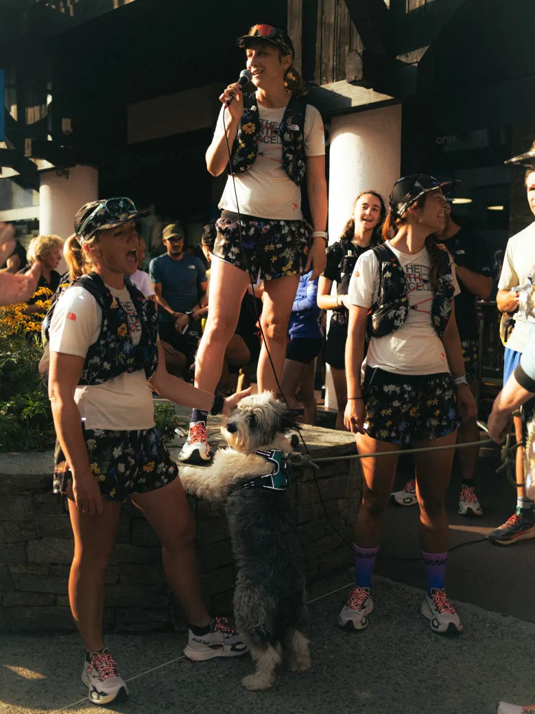 Three women wearing The North Face with a dog.
