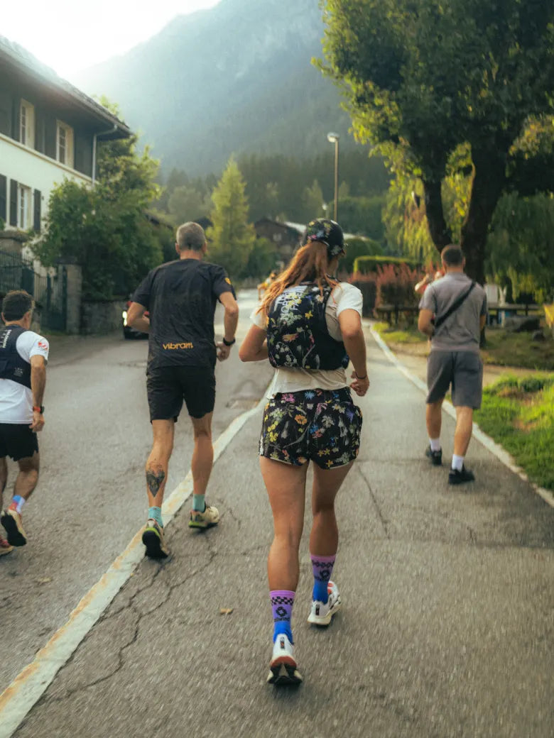 Four people running in an Alpine village.