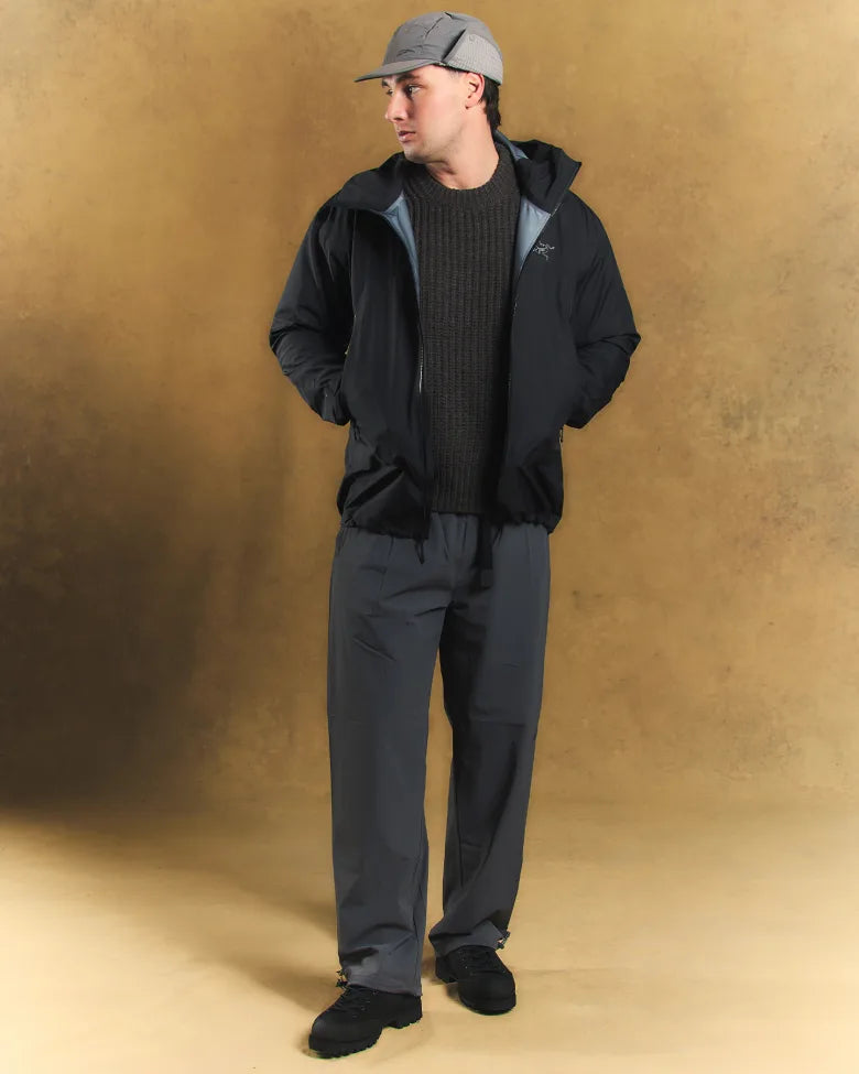 A man wearing a cap and an Arc'teryx coat.