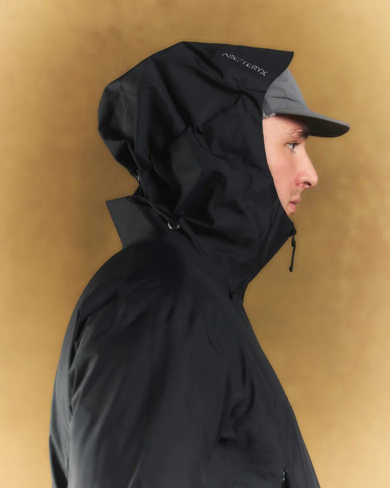 A man wearing a cap and an Arc'teryx coat.