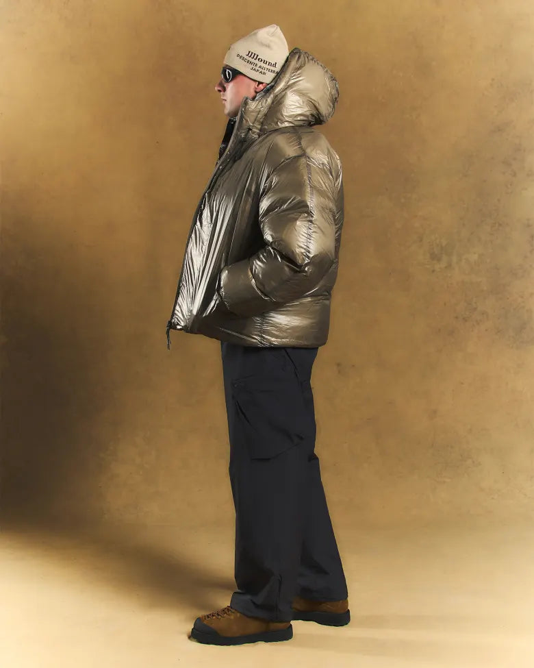 A man wearing a beanie and a puffer jacket.