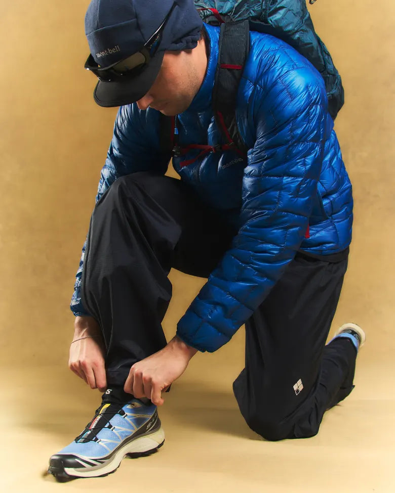 A man adjusting his Salomon XT-6 sneaker.