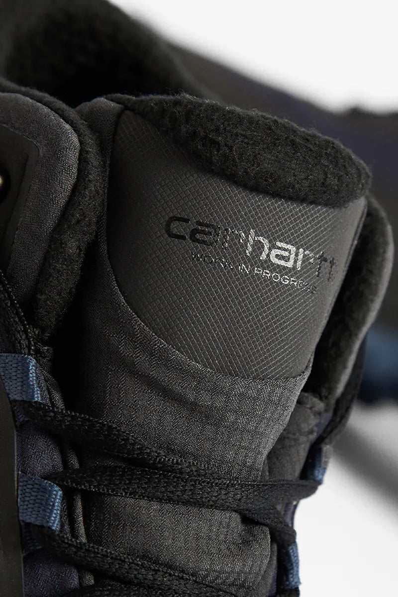 The tongue detail of the Salomon x Carhartt WIP Shelter CSWP boots.