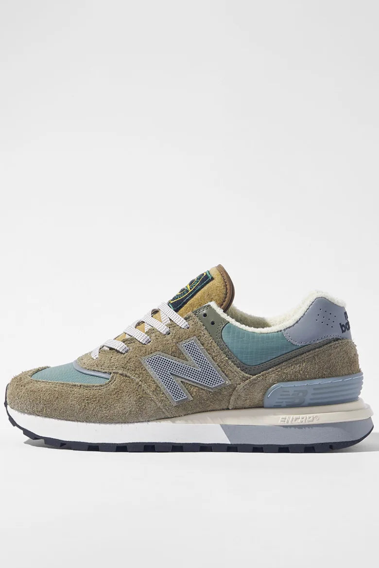 The side profile of the Stone Island x New Balance 574 Legacy sneaker.