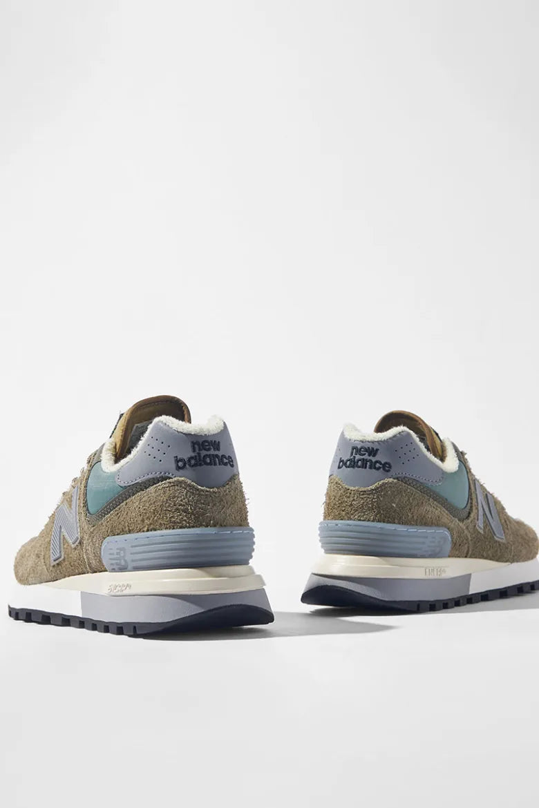 The heels of a pair of Stone Island x New Balance 574 Legacy sneakers.
