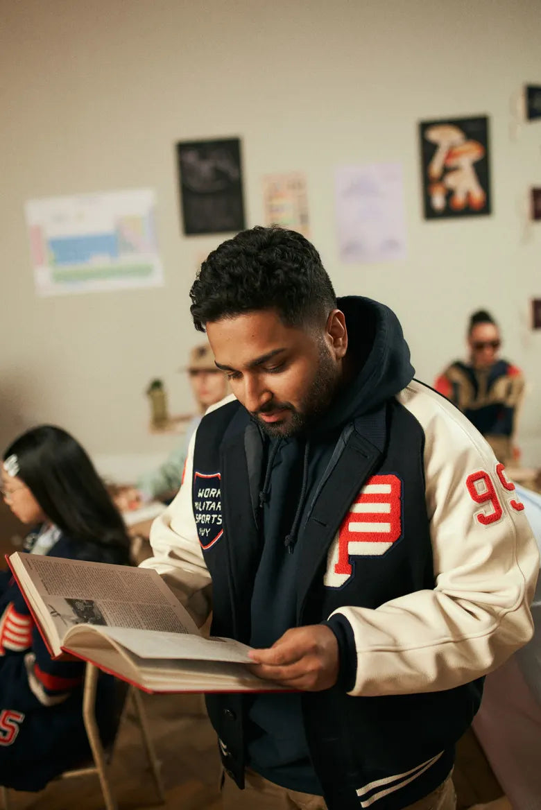  People in a classroom wearing the END. x Beams Plus Varsity collection.